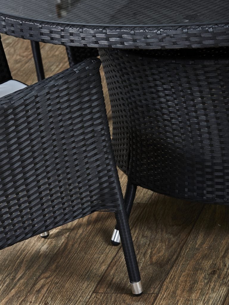 Black rattan table and chair. Rattan garden furniture. Small business