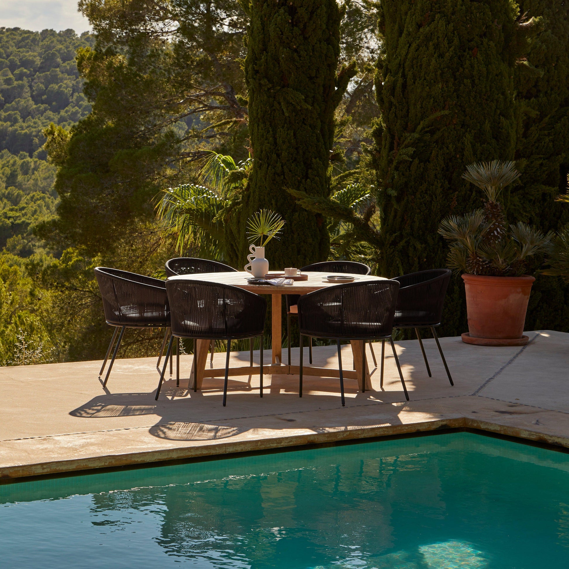 Shiro 6 seater wooden garden dining table with 6 Hali black rope chairs - Laura James