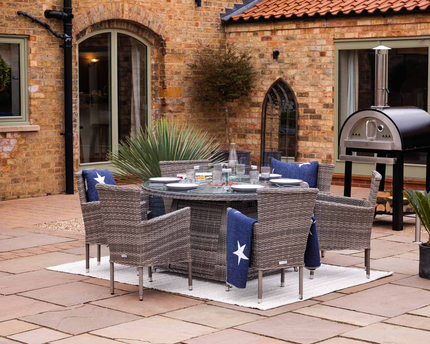 Product photograph of 6 Seat Rattan Garden Dining Set With Round Table In Grey With Fire Pit - Cambridge - Rattan Direct from Rattan Direct