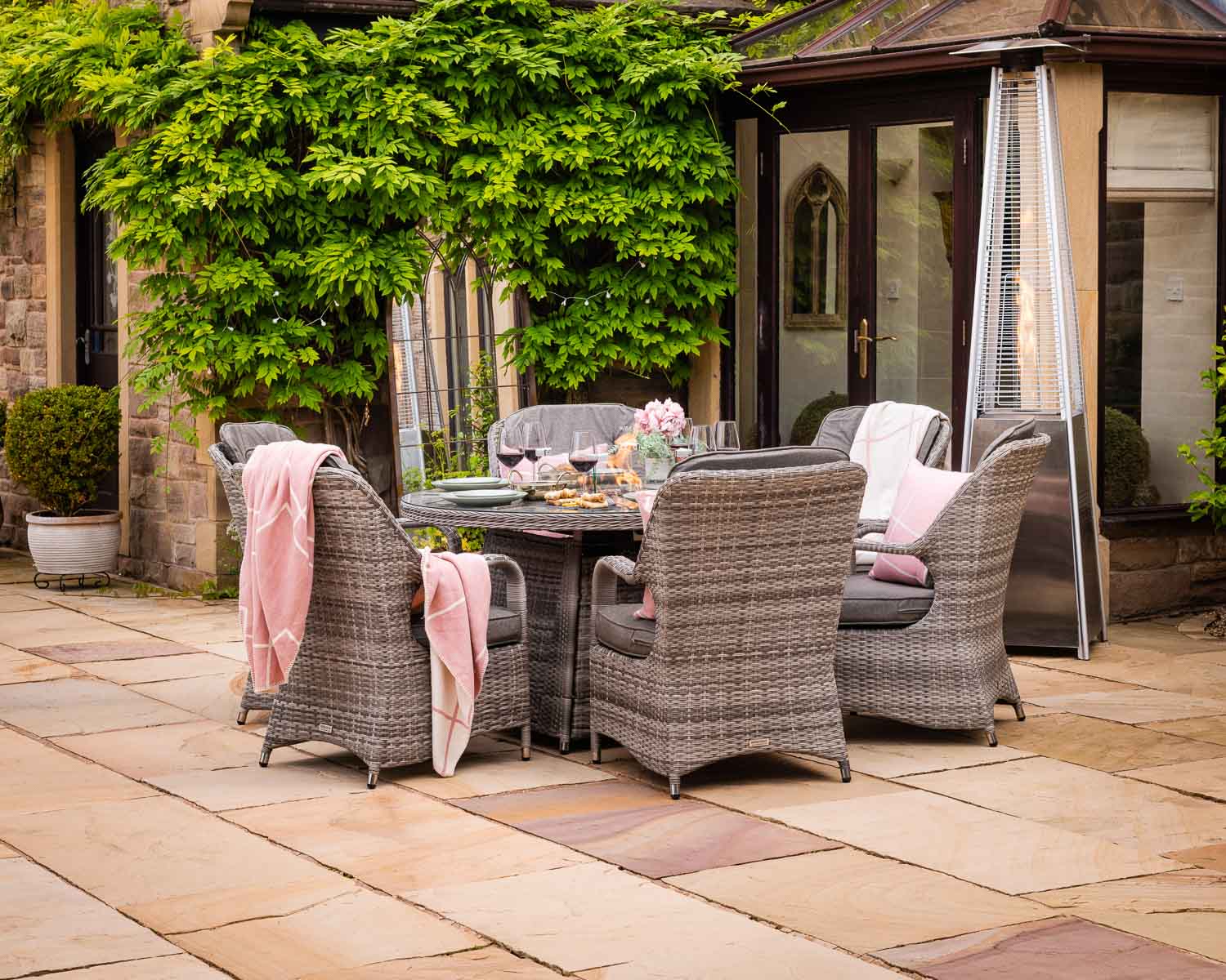 Product photograph of 6 Seat Rattan Garden Dining Set With Round Table In Grey With Fire Pit - Marseille - Rattan Direct from Rattan Direct