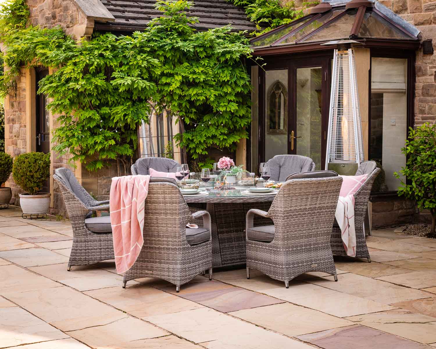 Product photograph of 6 Seat Rattan Garden Dining Set With Large Round Table In Grey With Fire Pit - Marseille - Rattan Direct from Rattan Direct