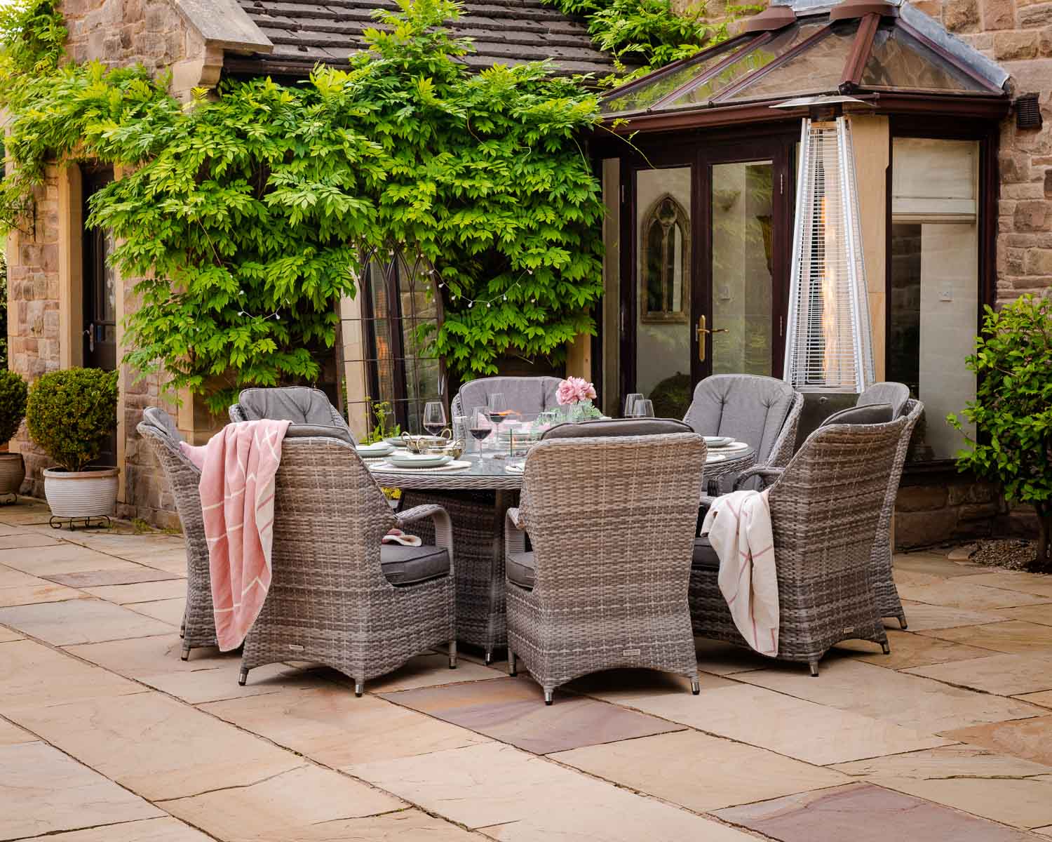 Product photograph of 8 Seater Rattan Garden Dining Set With Large Round Table In Grey With Fire Pit - Marseille - Rattan Direct from Rattan Direct