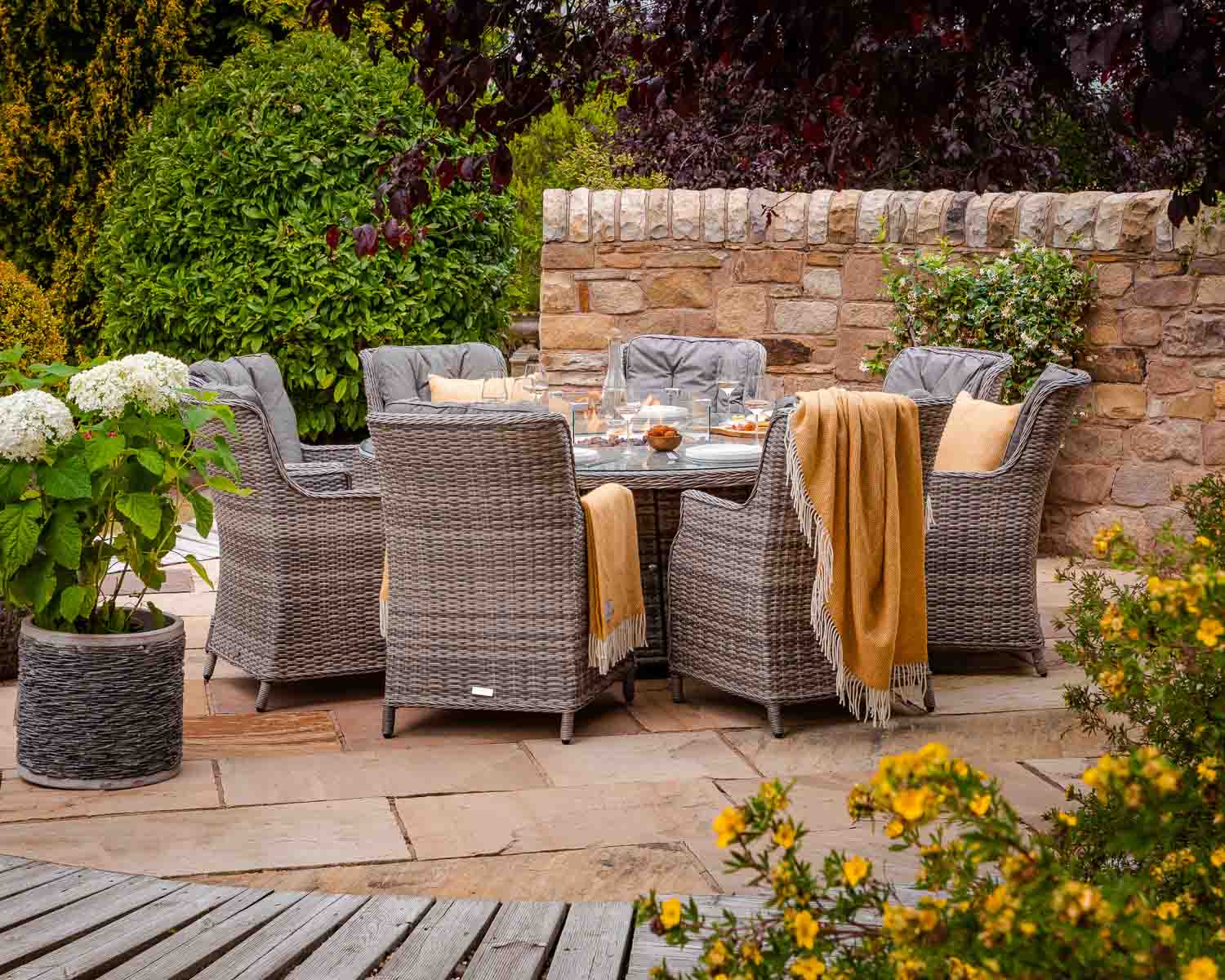Product photograph of 8 Seater Rattan Garden Dining Set With Large Round Table In Grey With Fire Pit - Riviera - Rattan Direct from Rattan Direct