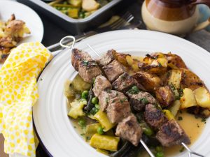 Easy Easter lamb recipe; lamb skewers with braised spring veg and crispy smashed potatoes