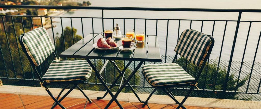 A picture of some outdoor furniture and food on a balcony: how to prepare for spring