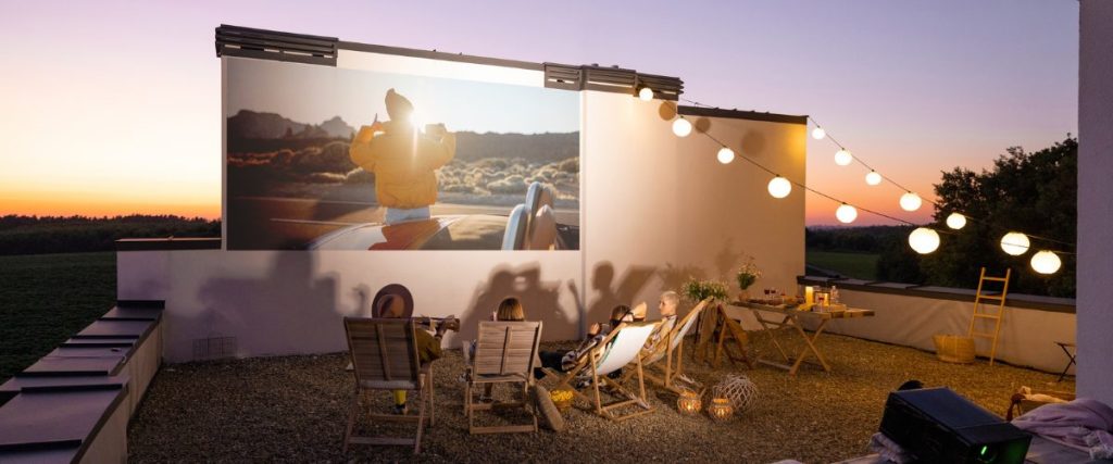 A picture of people watching a movie outdoors: alfresco entertaining