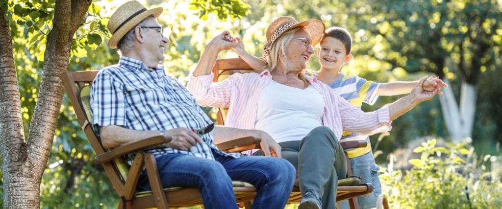 A picture of grand parent s and their grandchild spending time in the garden: Outdoor party seating ideas 