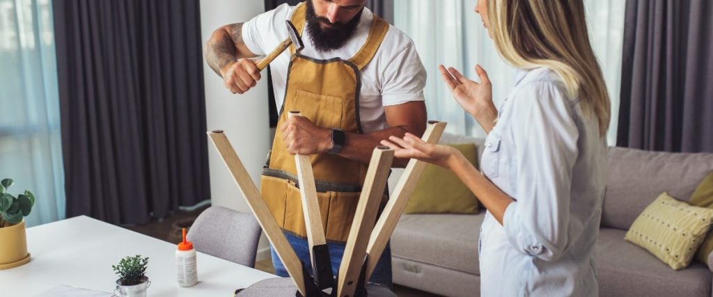 A picture of someone fixing chair legs: how to repair rattan furniture