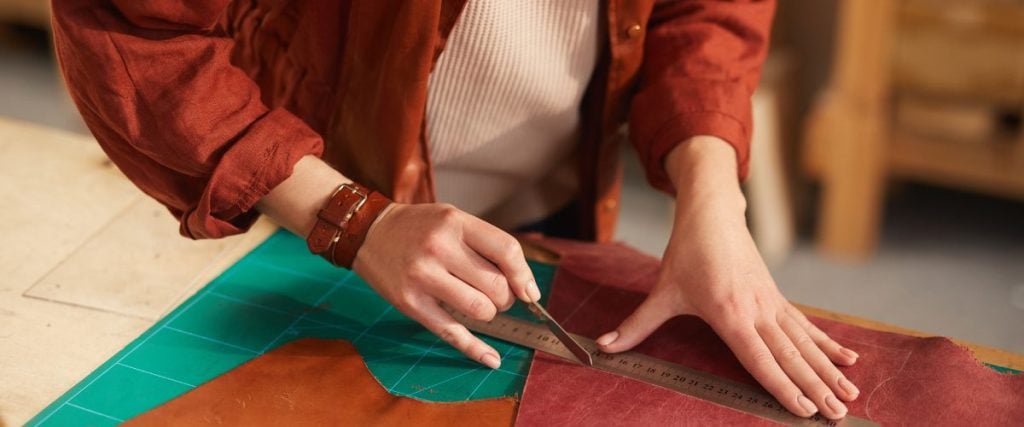 A picture of someone cutting some excess material: how to repair rattan furniture 